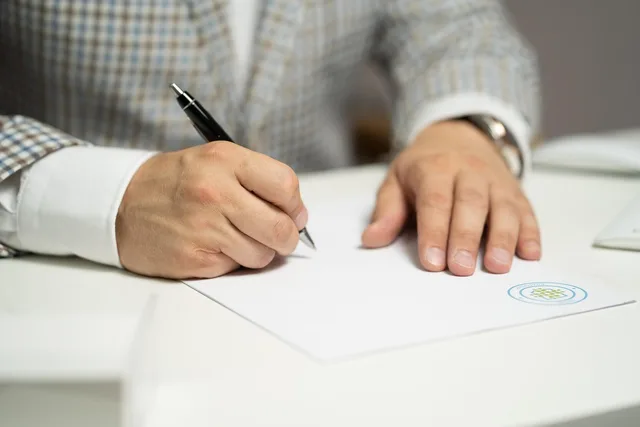 man, sign, paper, write, document, contract, signing, agreement, signature, signing document, signing contract, signing paper, sign, contract, contract, contract, contract, contract, signing, agreement, signature, signature. How Glasgow wellness creators can work with NHS Scotland